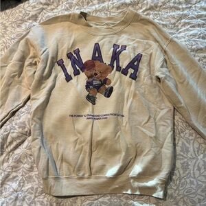 Inaka Power Beige Sweater with Purple Accents